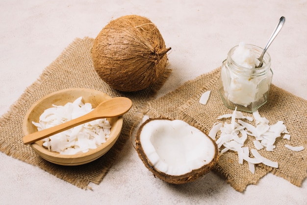 Free photo coconut oil and nut on sackcloth pieces