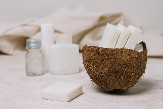 Coconut soap bars in coconut bowl with oils