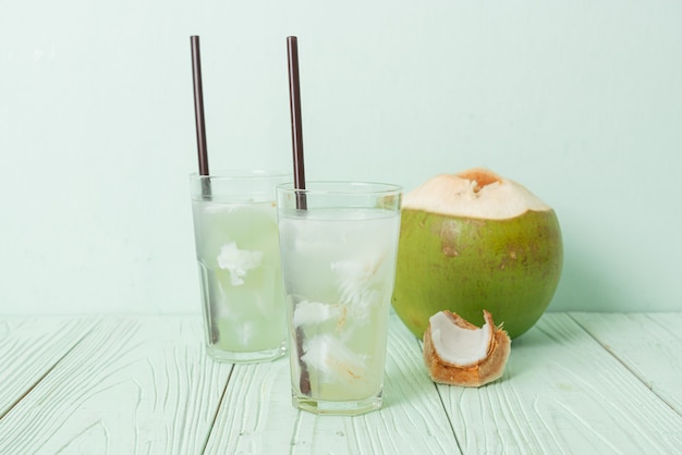 Coconut water or coconut juice in glas with ice cube