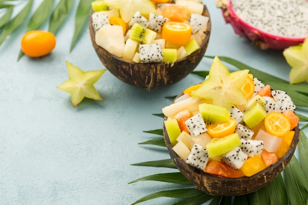 Coconuts filled with fruit salad and yogurt