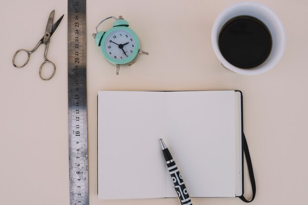 Coffee and alarm clock near craft supplies