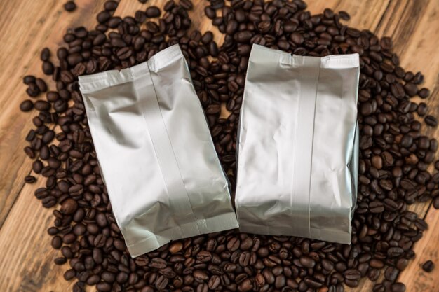 Coffee bags with coffee beans around