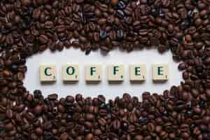 Free photo coffee beans around writing