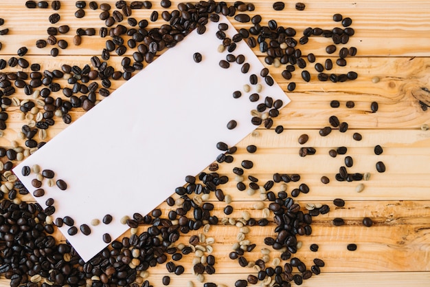 Coffee beans on blank envelope