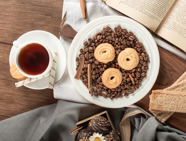 Free photo coffee beans, cookies and a cup of tea. top view