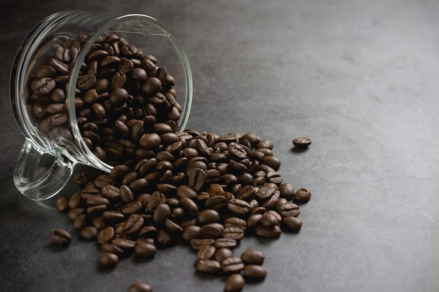 Coffee beans in cup on table