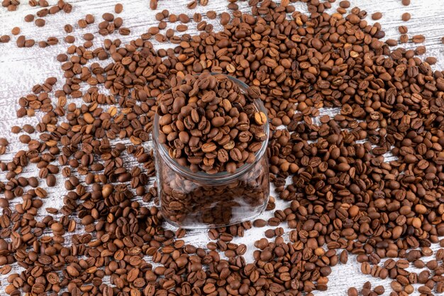 coffee beans in glass jar and table