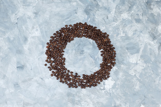 Coffee beans on a grey plaster background. flat lay.
