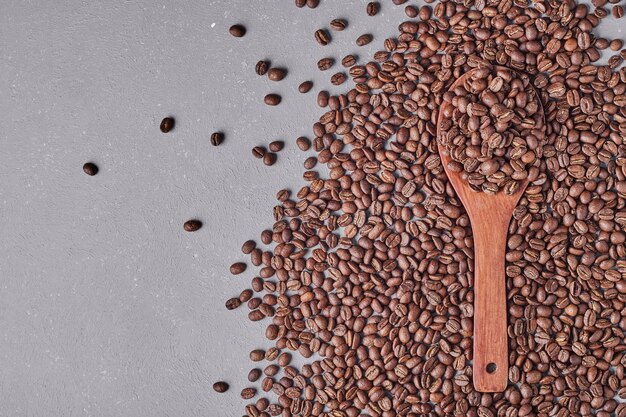 Coffee beans isolated on blue background.