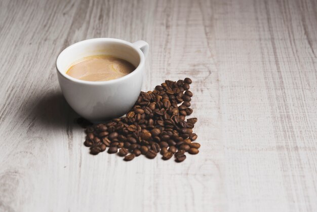 Coffee beans near cup