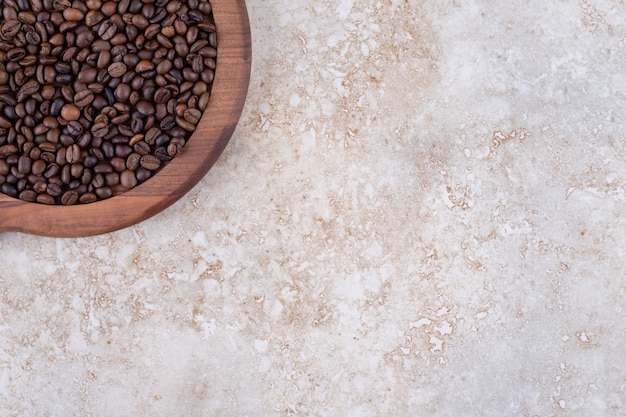 Coffee beans piled on a wooden tray 