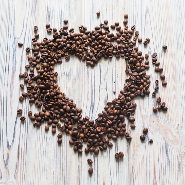 Coffee beans scattered in shape of heart