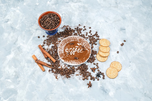 Coffee beans and spices on grunge background