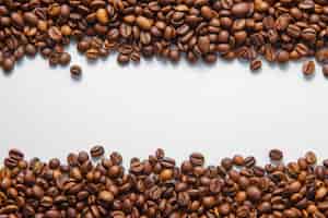 Free photo coffee beans top view on a white background space for text
