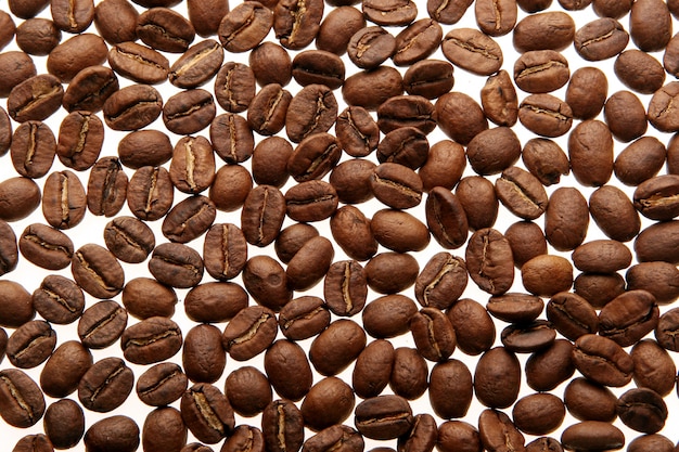 Coffee beans over white background