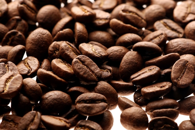 Coffee beans over white background