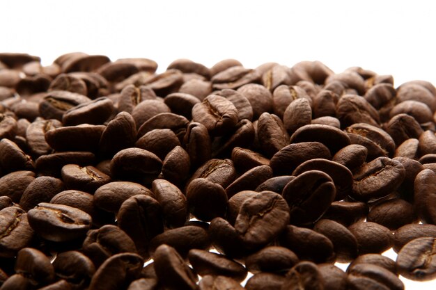 Coffee beans over white background