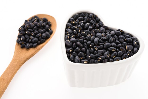 Coffee beans in a wooden spoon and a heart shaped mold