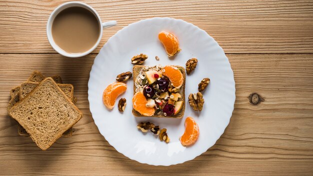 Coffee and bread near fruit toast