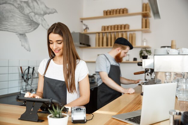 Coffee Business Concept beautiful caucasian bartender barista or manager Posting order in digital tablet menu at modern coffee shop