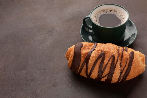 Coffee and chocolate croissant close up