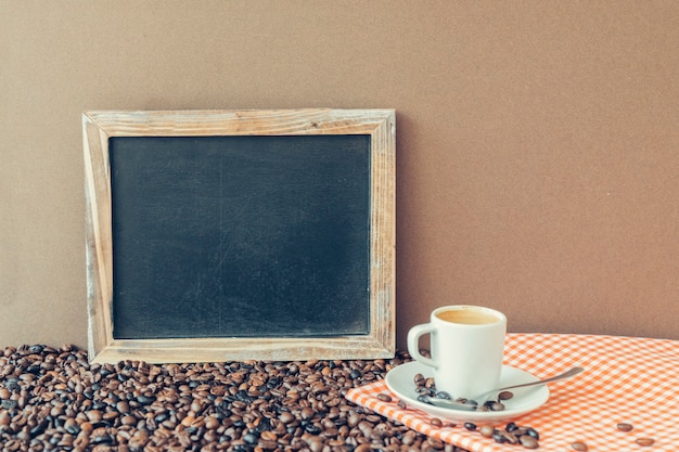 Coffee concept with slate next to espresso on cloth