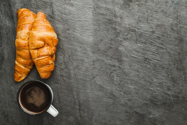 Coffee and croissants on gray