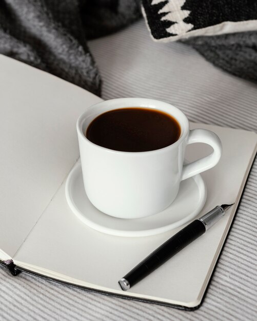 Coffee cup on book high angle