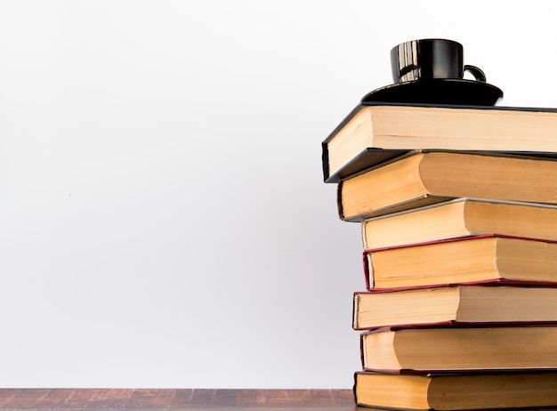 Coffee cup on a book pile