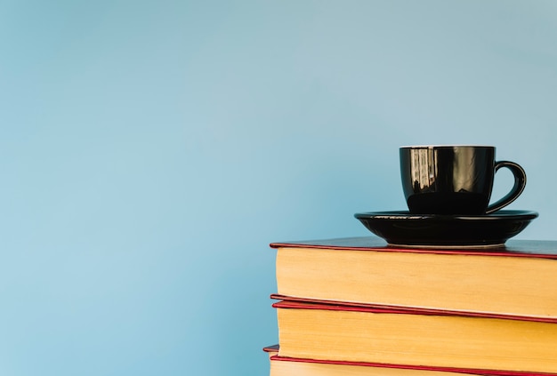 Coffee cup on a book pile