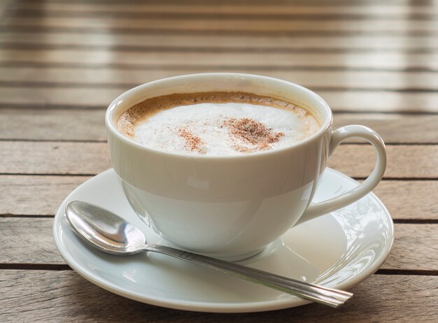 Coffee cup over brown plank wood table