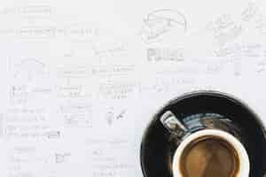 Free photo coffee cup on business plan paper