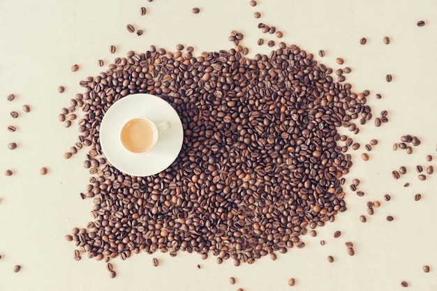 Coffee cup on coffee beans