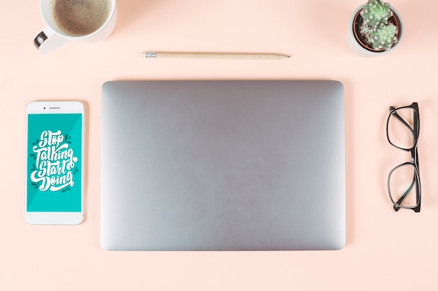 Coffee cup; pencil; eyeglasses; cactus pot; smart phone and laptop on colored background