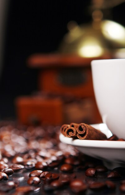 Coffee cup on the table with coffee beans around