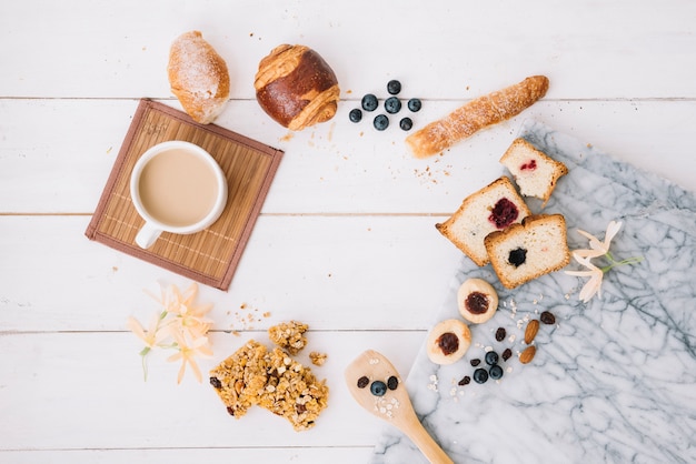 Coffee cup with bakery on wooden table