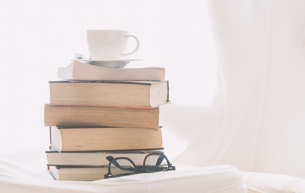 Coffee cup with book and eyeglasses