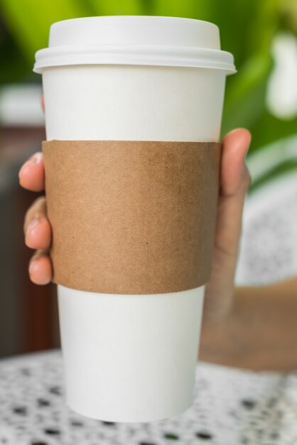 Coffee cup with cardboard to catch it