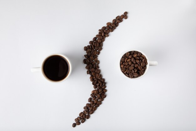 Coffee cup with coffee beans isolated on white