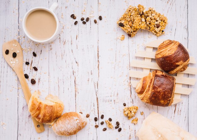 Coffee cup with different bakery on wooden table