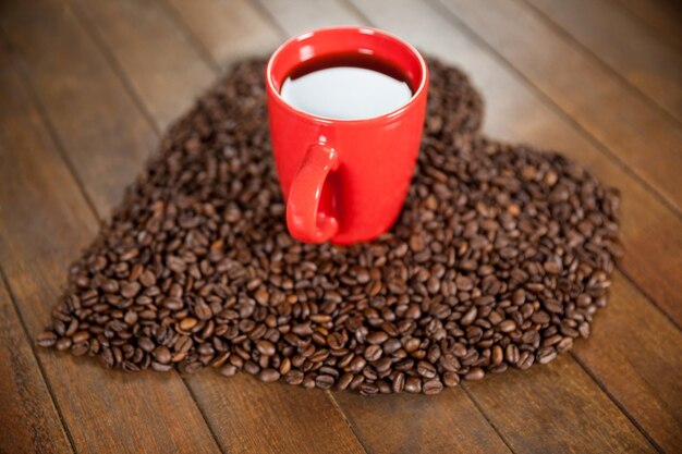 Coffee cup with heart shaped coffee beans