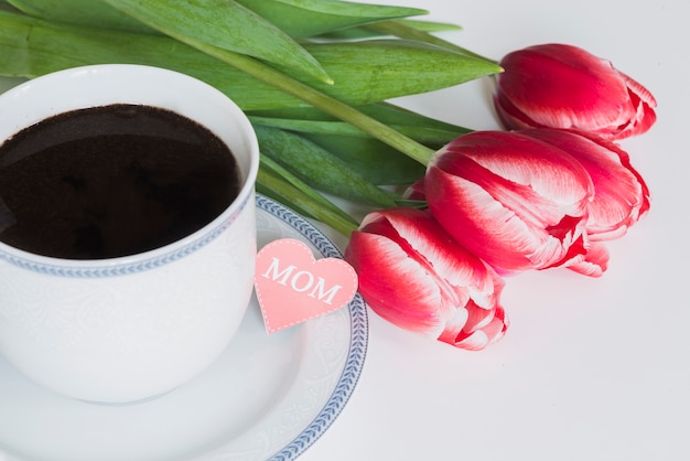 Free photo coffee cup with tulips for mother's day