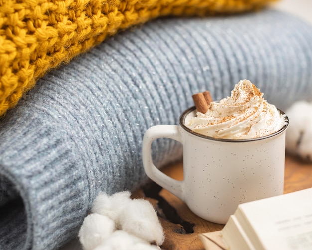 Coffee cup with whipped cream and sweaters