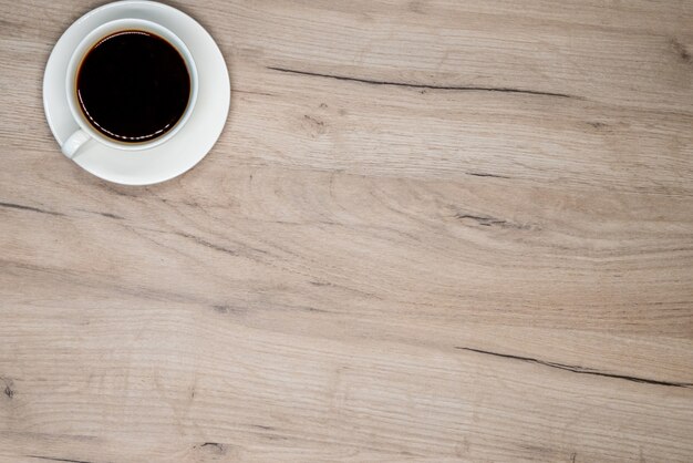 Coffee cup on wooden board