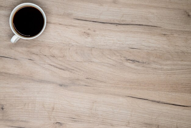 Coffee cup on wooden board