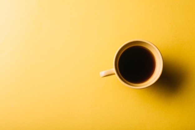Coffee cup on yellow background