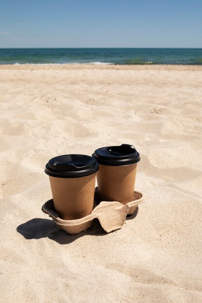 Coffee cups on beach high angle