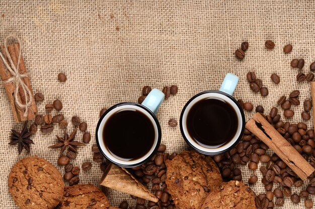 Кофейные чашки и бобы обрамление с печеньем.
