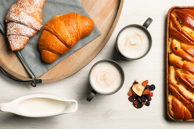 Free photo coffee cups with croissants