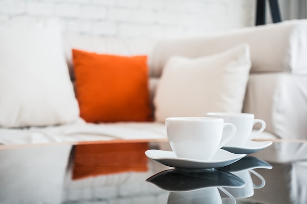 Free photo coffee cups with sofa background